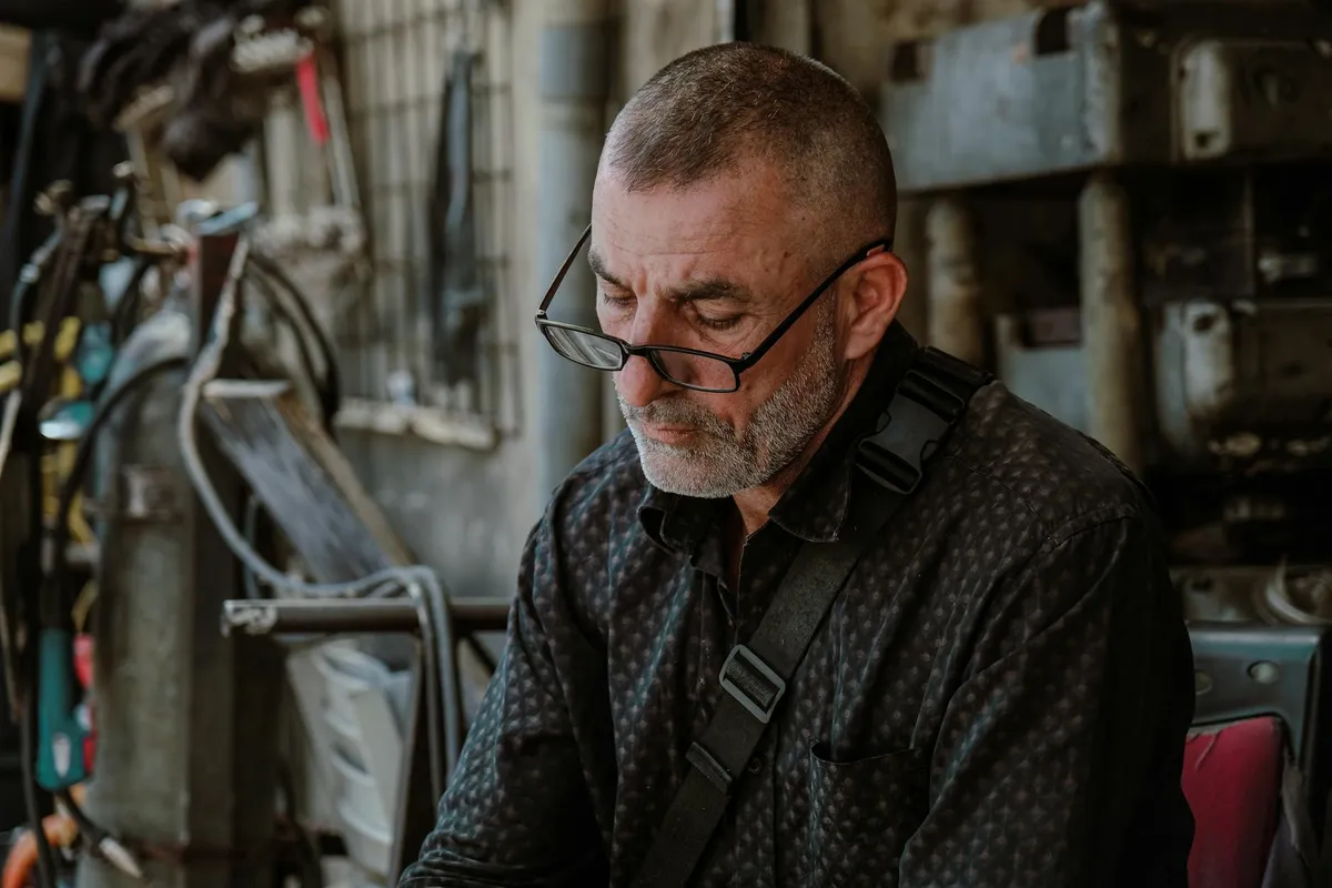 A mature photographer reviewing work